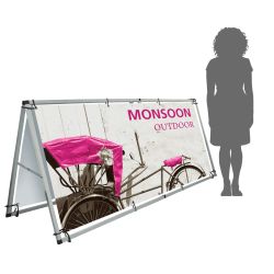 Monsoon display next to woman for scale